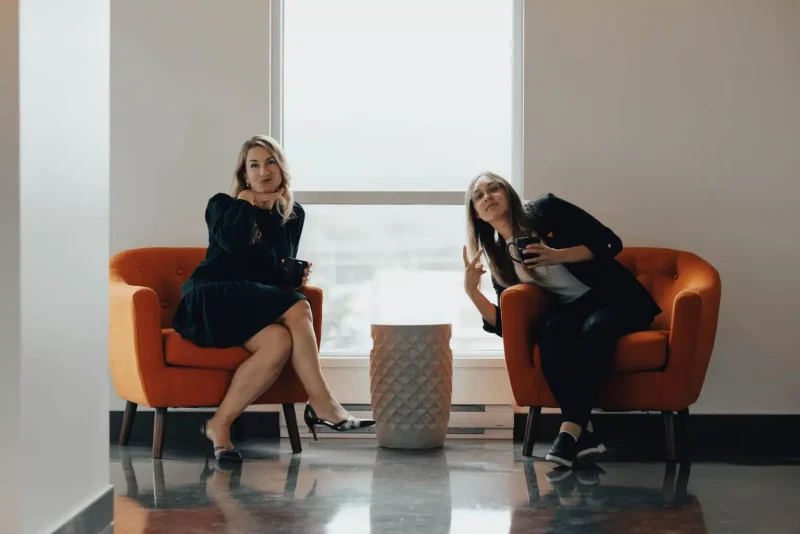 Two Kezber colleagues talking in an office lounge